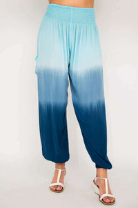 Angled front view of Embra ombre blue pants showcasing loose fit and waistband