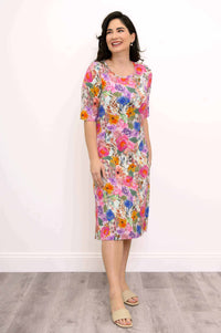 Woman smiling and wearing a floral bamboo dress, angled front view