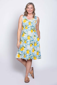 Angled front view of woman posing in sleeveless lemon tile dress