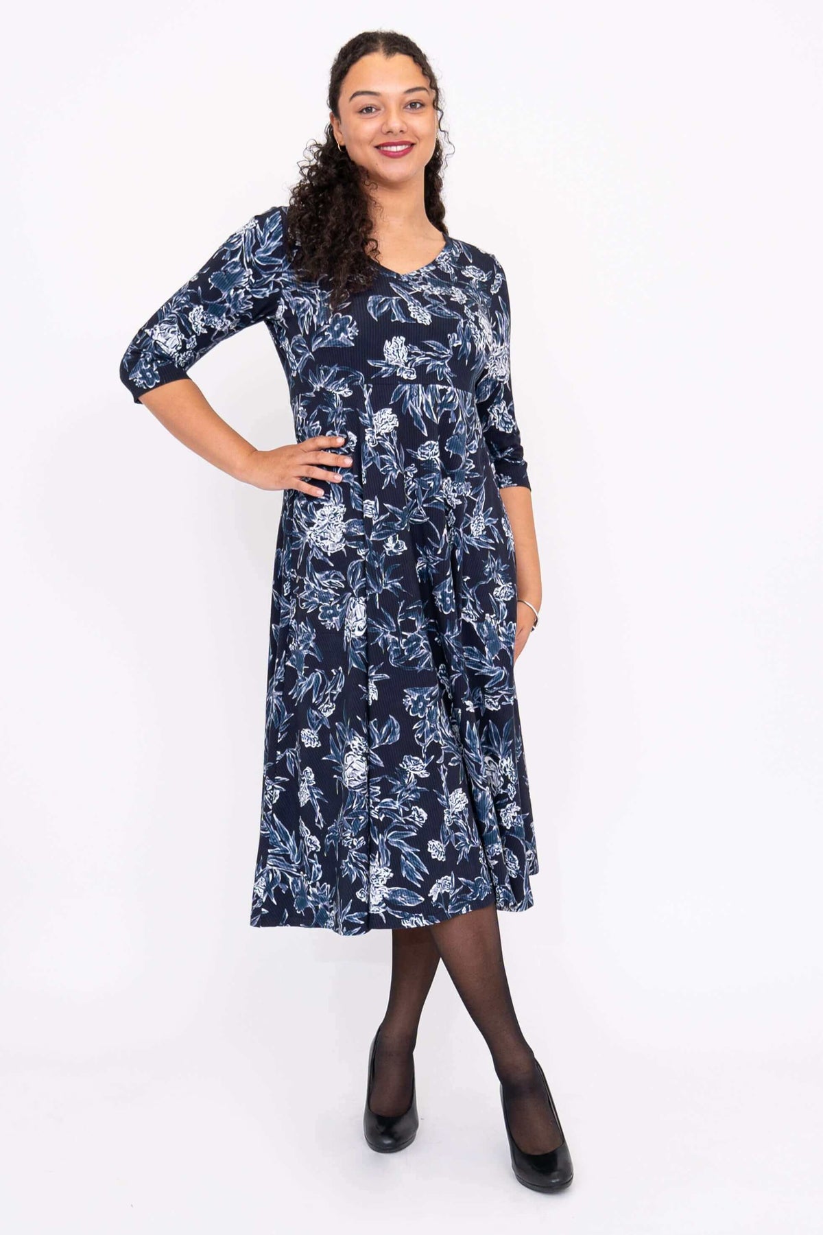 Angled front view of navy floral midi dress with feminine silhouette