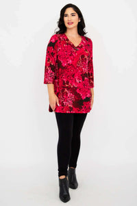 Angled front view of woman in Vana tunic, black leggings, and ankle boots