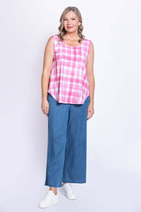 Angled full body shot of woman in pink plaid tank top and denim wide-leg pants