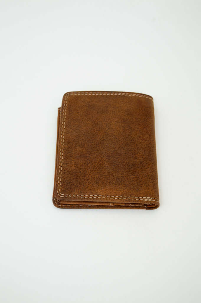 Angled view of the closed brown buffalo leather wallet showcasing stitching