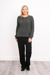 Front view of a women's graphite long-sleeve knit top, showcasing a textured plaited pattern on a model.