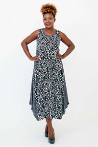 Model with hands on hips wearing a black and blue print midi tank dress