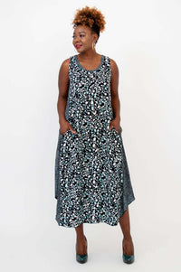 Model showing side seam pockets on black and blue patterned tank dress