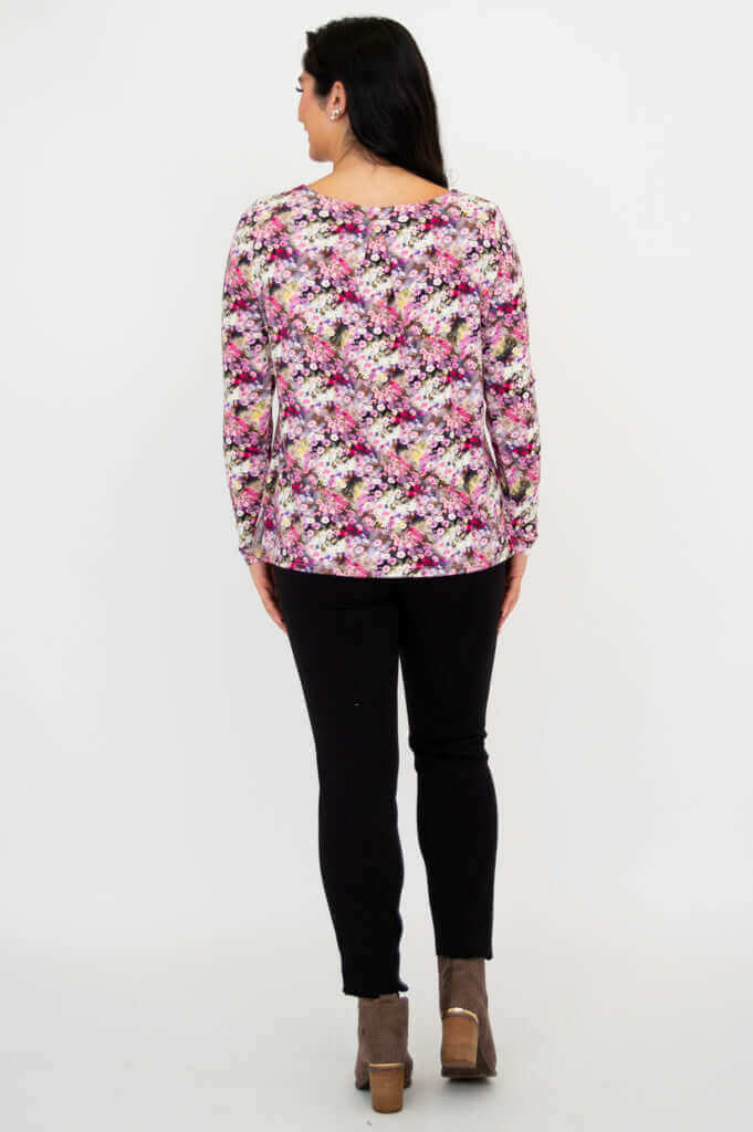 Back view of woman wearing floral bamboo top and black pants