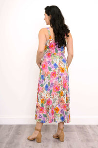 Back view of a woman in a colorful floral fit and flare maxi dress