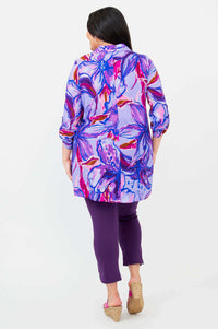 Rear view of model wearing a purple pink floral tunic showcasing back design