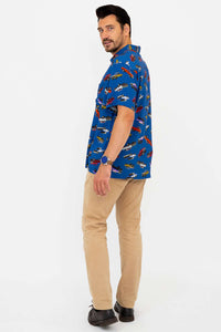 Back angled view of man wearing blue monster truck print shirt