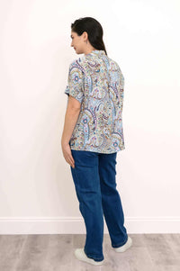 Back angled view of model in Carolina Paisley Blouse displaying the relaxed high-lo hem