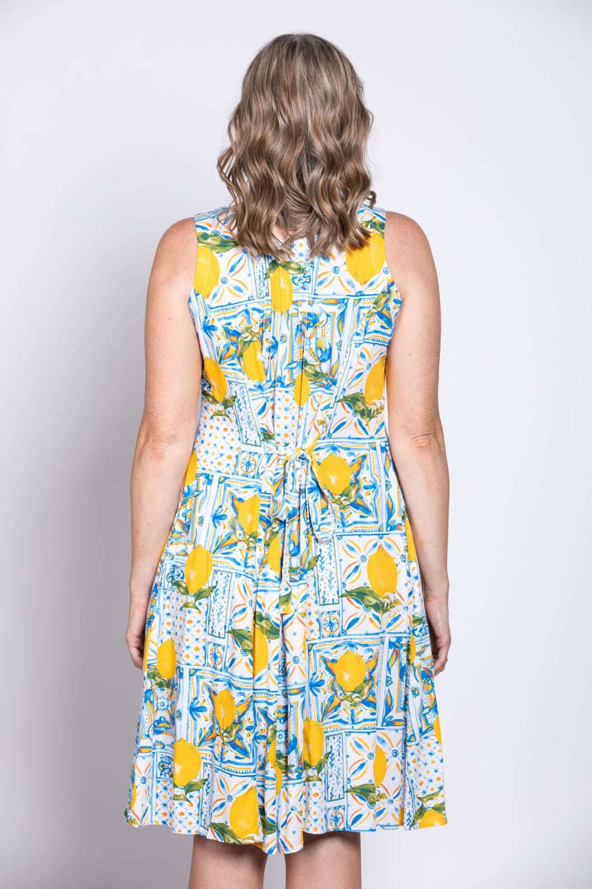Close-up back of sleeveless dress showing tie detail and lemon print