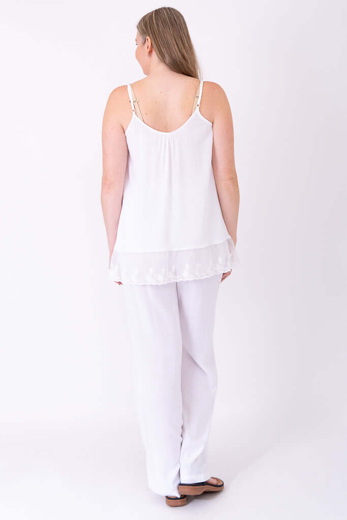 Back view of model wearing white Chantilly Lace Tank and pants