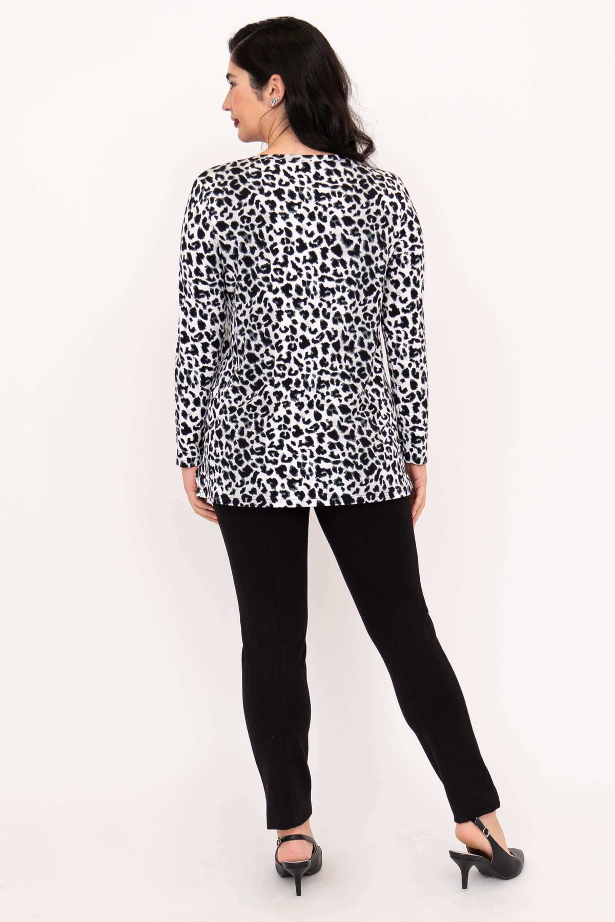 Back view of woman in Margie leopard print long sleeve top and black pants
