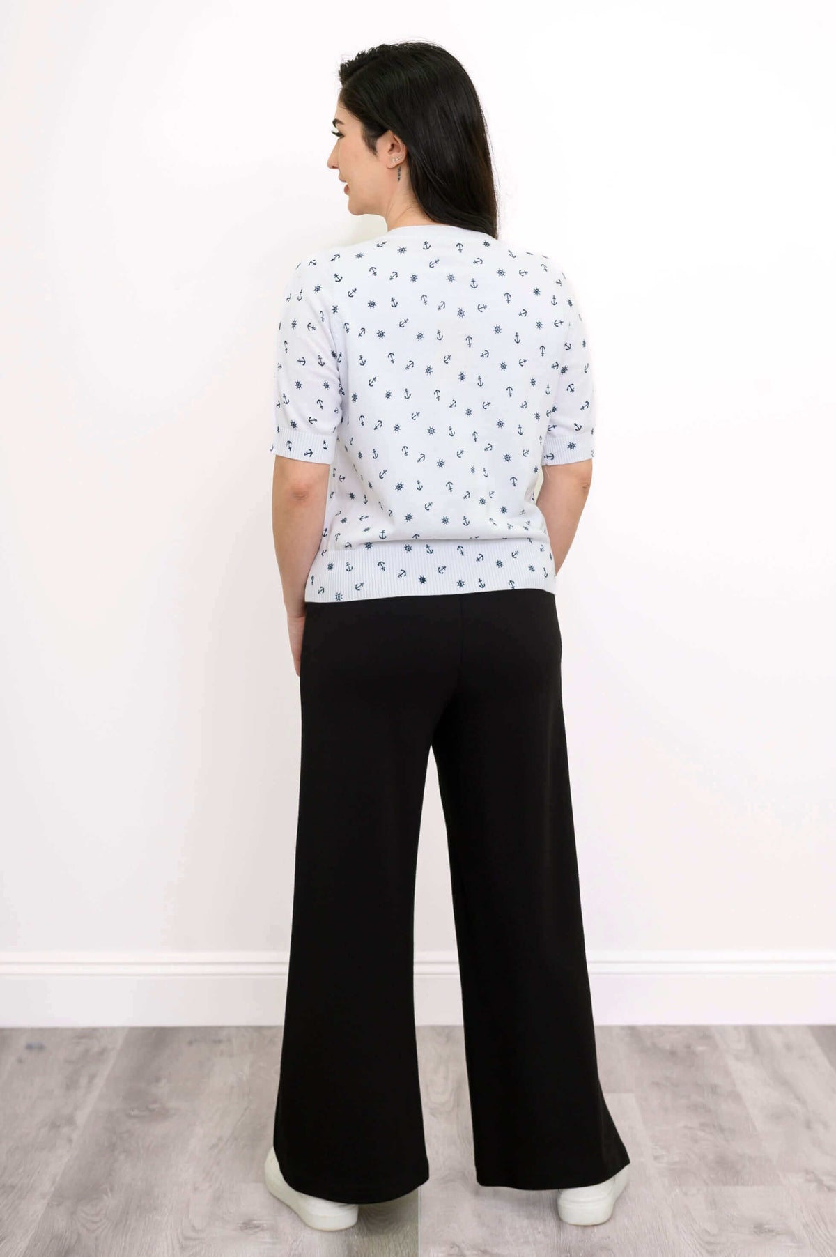 Back view of Shen nautical short sleeve cardigan paired with black pants
