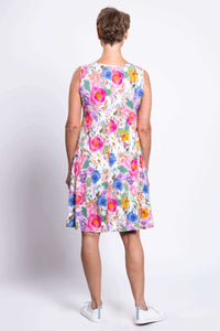 Back view of woman wearing sleeveless flared dress in pink pastel floral print