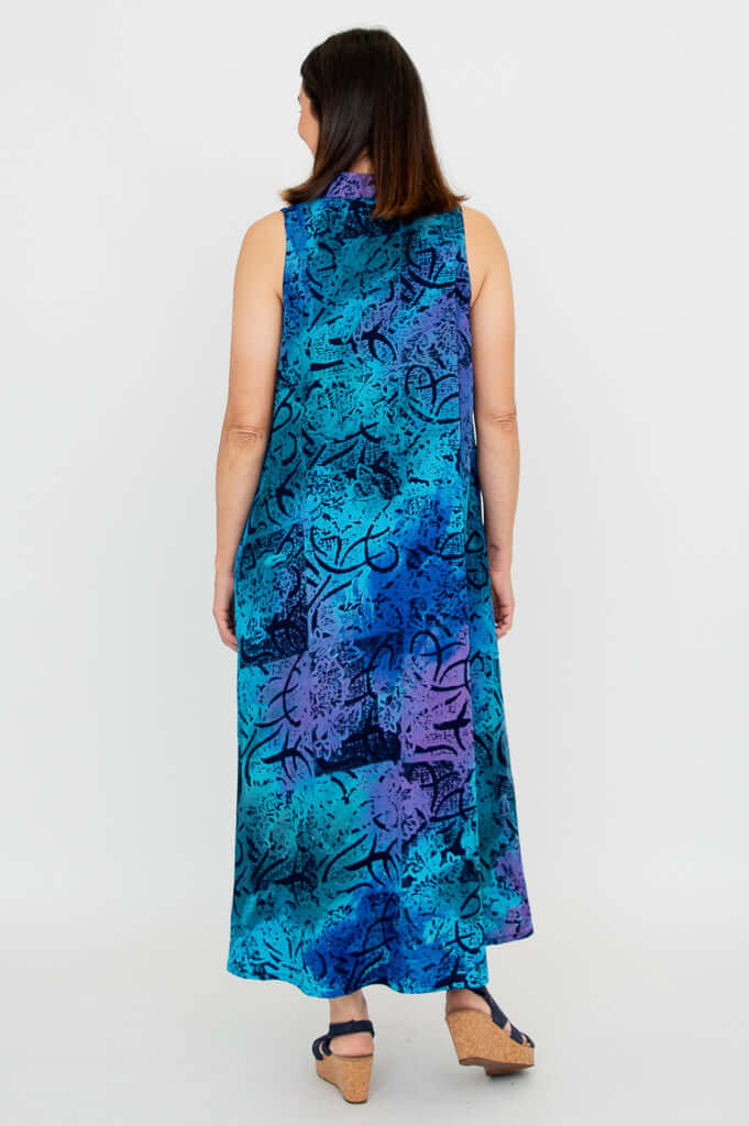 Back view of a woman wearing a sleeveless blue and purple A-line dress