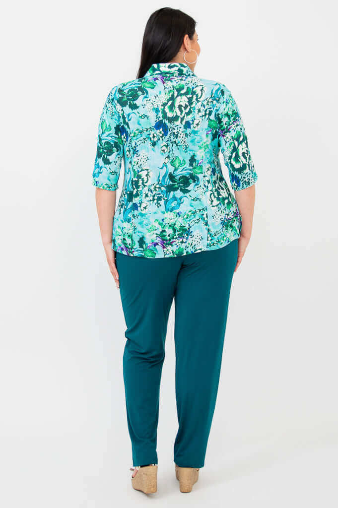 Back view of blue floral blouse showing princess seams and elbow-length sleeves