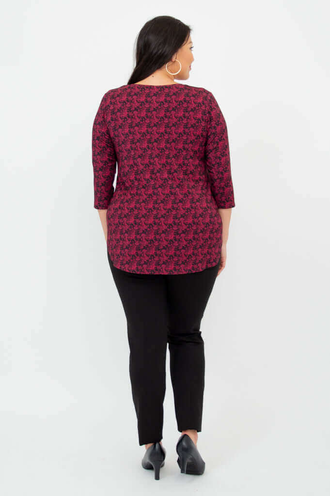 Back view of coral print V-neck bamboo top showing curved hemline
