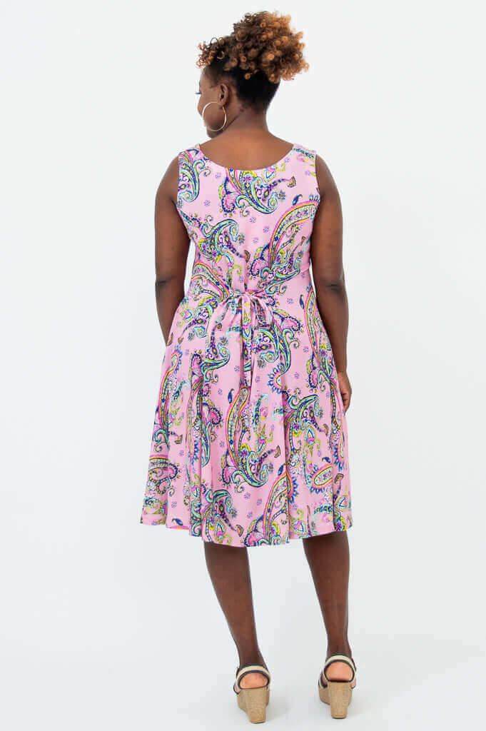 Back view of pink paisley dress featuring a tie-belt detail
