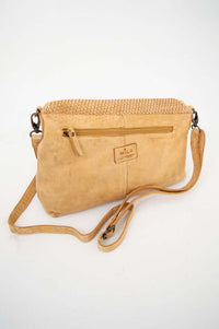 Back view of tan leather crossbody bag with zip pocket and strap