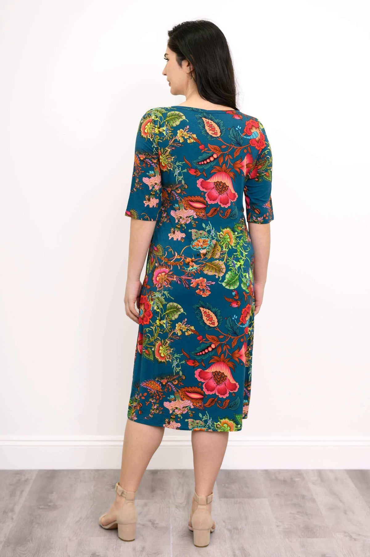 Back view of teal floral bamboo midi dress with short sleeves and knee-length fit