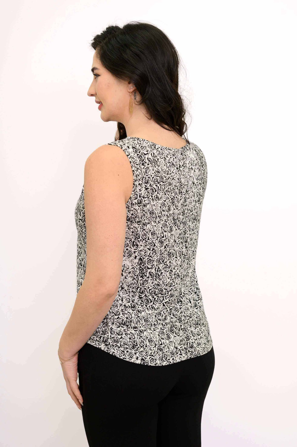 Back side view of woman in black and white floral tank top