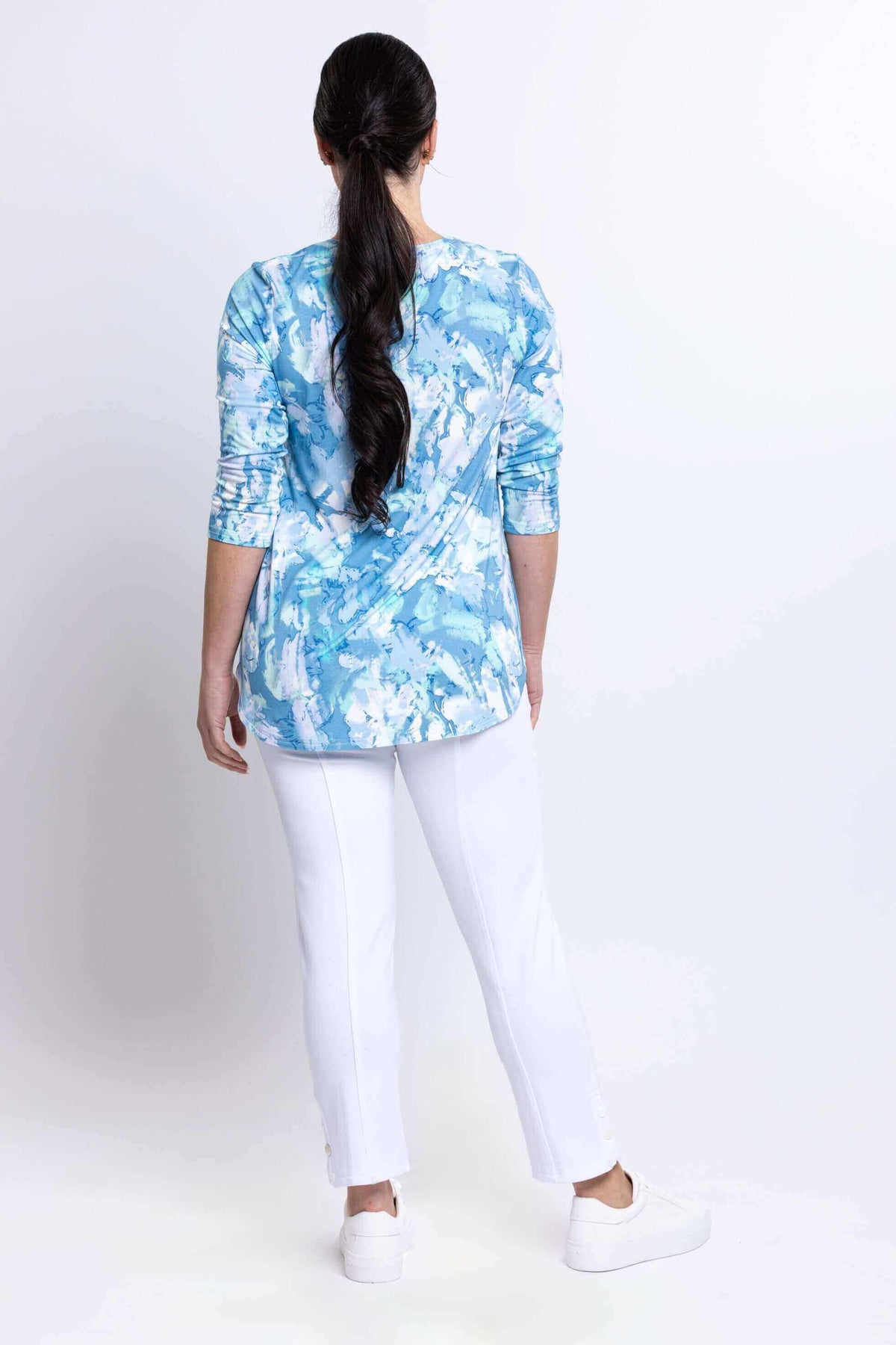 Back view of model in blue watercolor Jazz Top showing rear fit