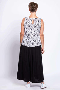 Rear view of woman wearing sleeveless floral tank top showing back button closure