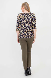 Back view of woman in leopard print long sleeve top and olive pants