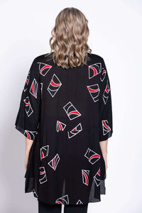 Back view of a woman showing the length and pattern of a black tunic blouse
