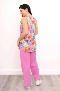 Back view of model showing floral bamboo tank top with curved hem
