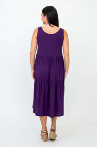 Back view of woman wearing plum sleeveless tiered dress
