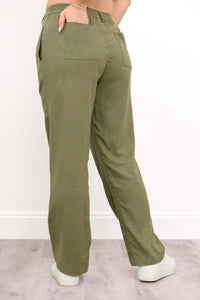 Back view highlighting rear pockets and elastic waistband of the olive green pants