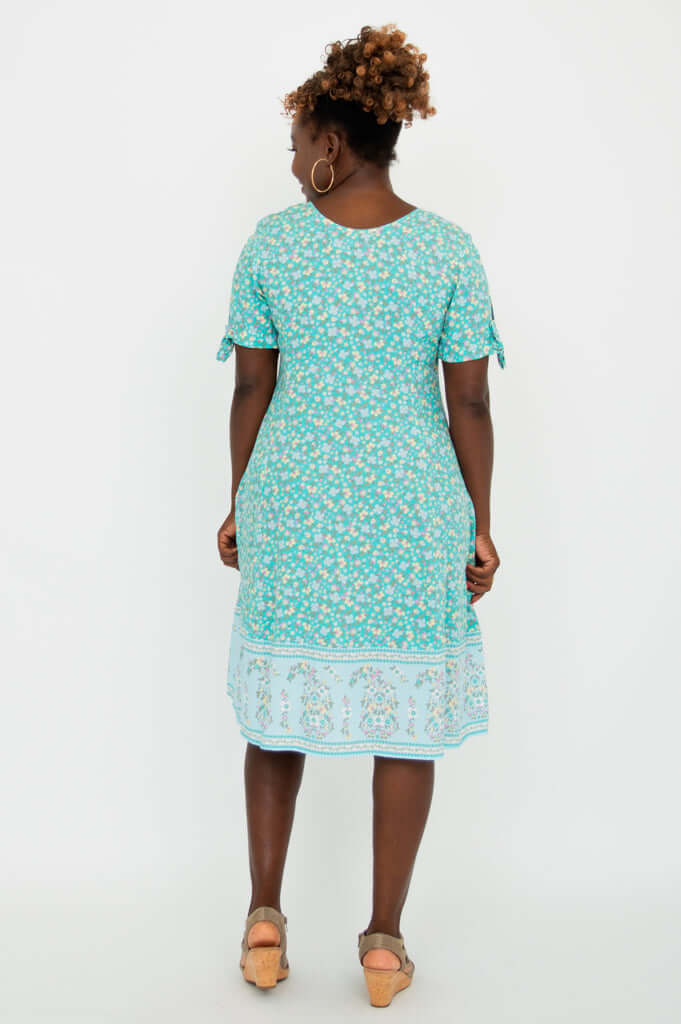 Back view of woman in teal floral Renee Dress showing dress silhouette
