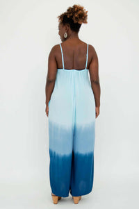 Back view of model in blue ombre jumpsuit with adjustable spaghetti straps