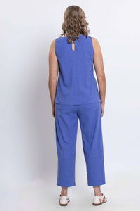 Back view of woman wearing blue tank top showing back button detail