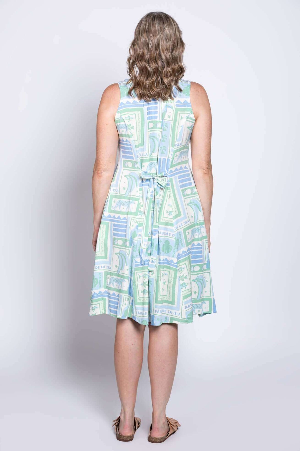 Back view of the Arden dress, showcasing the tie-back detail and breezy fabric
