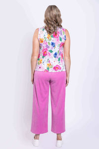 Back view of woman wearing a floral tank top and bright pink pants, showing tank detail