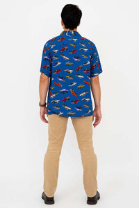 Back view of man in blue monster truck print shirt and khaki pants