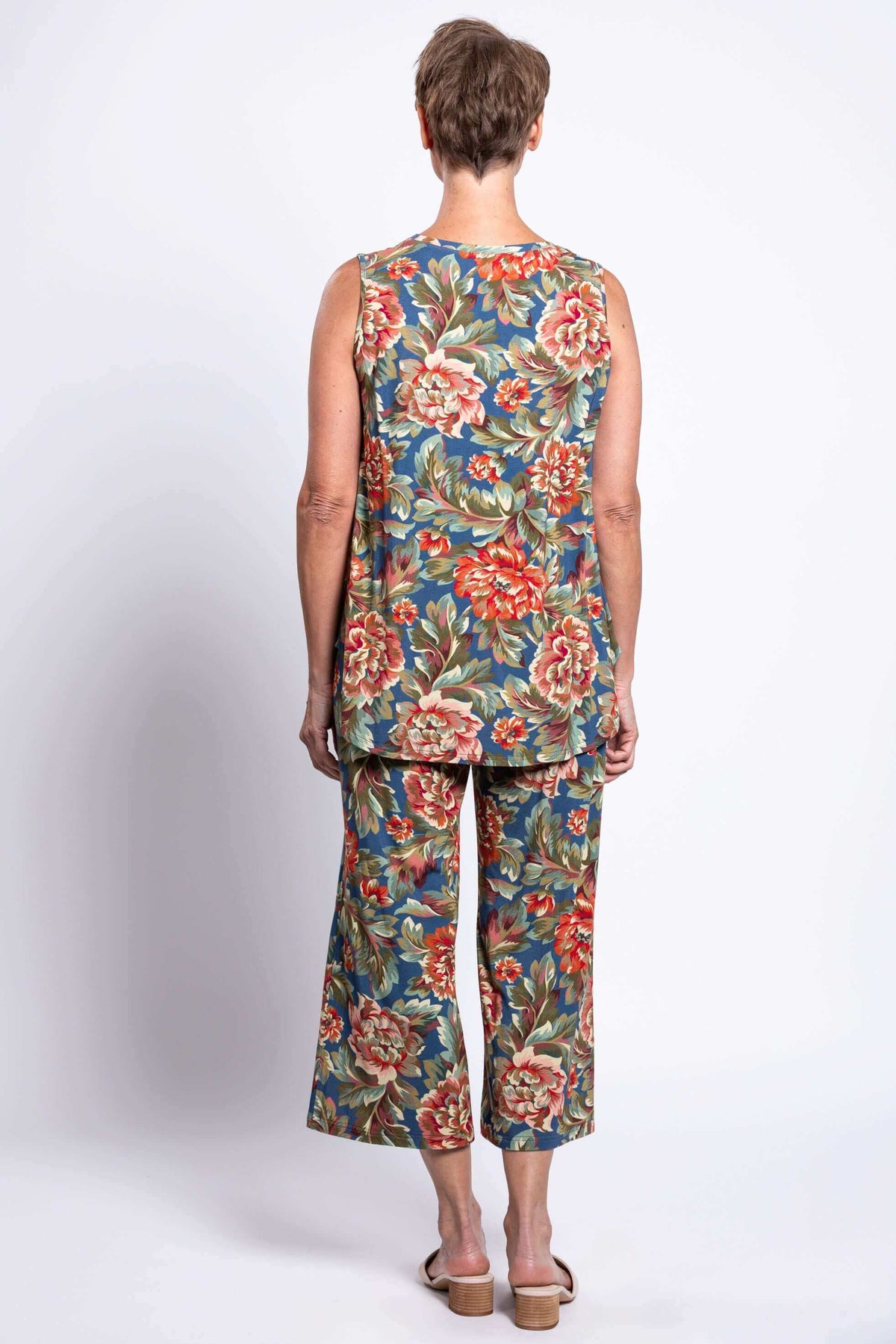 Back view of model showing floral crop pants and tank set