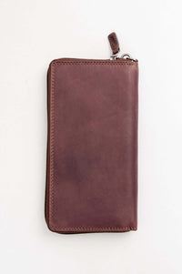 Back view of a closed Adrian Klis brown leather zip wallet