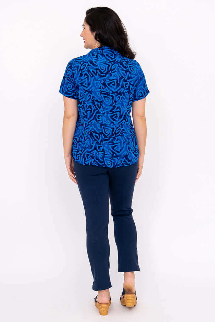 Back view of Aida Top in blue abstract print worn by woman
