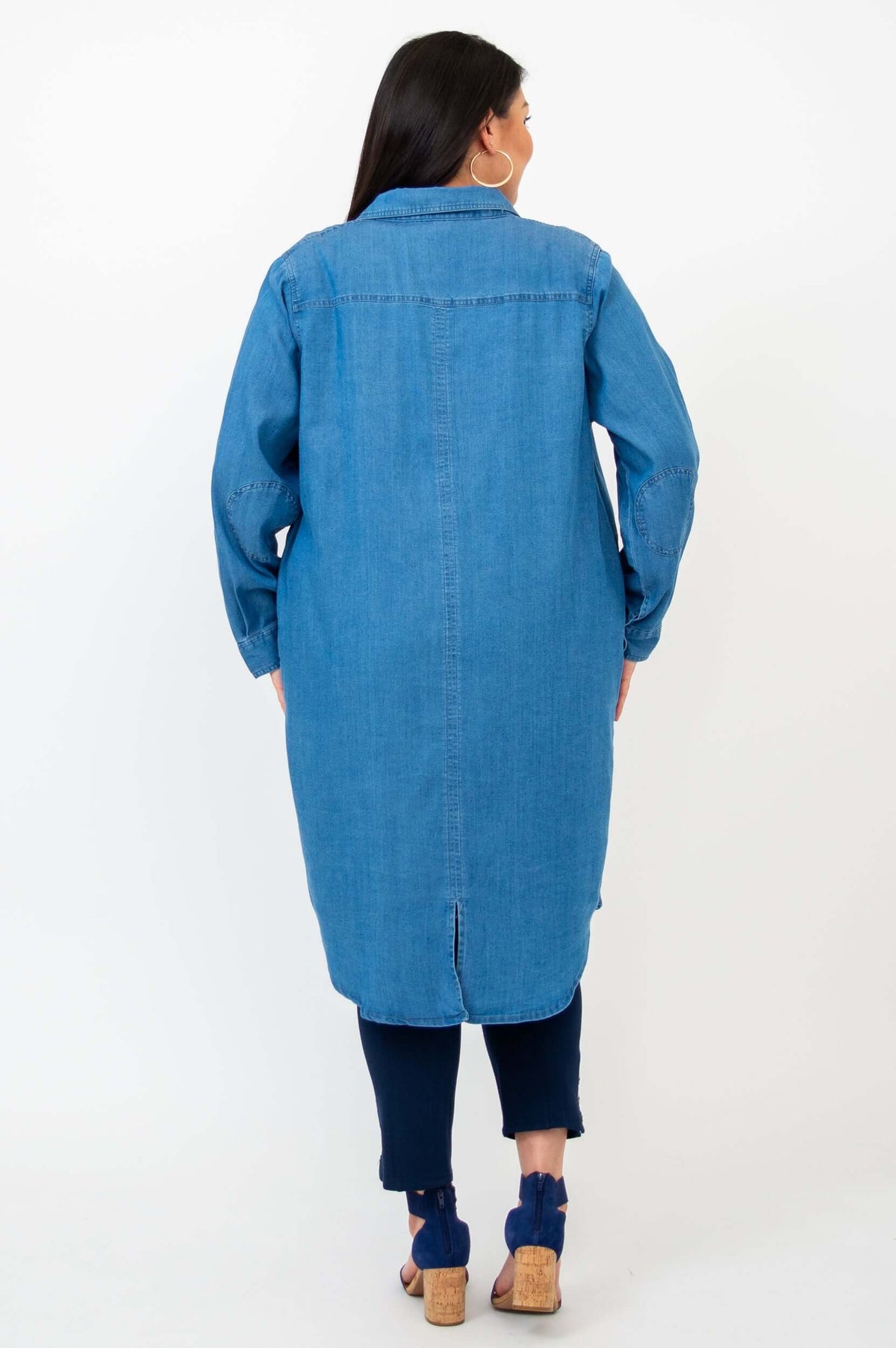 Back view of woman wearing a blue Anka denim duster with shirttail hem