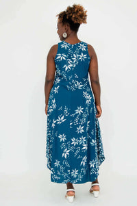 Back view of woman in blue midi tank dress with white floral print