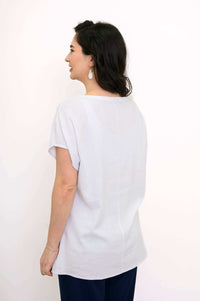Back view of woman in white linen blend dolman sleeve tee