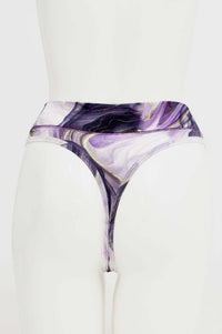 Back view of high-rise thong underwear in purple and gold abstract print on mannequin