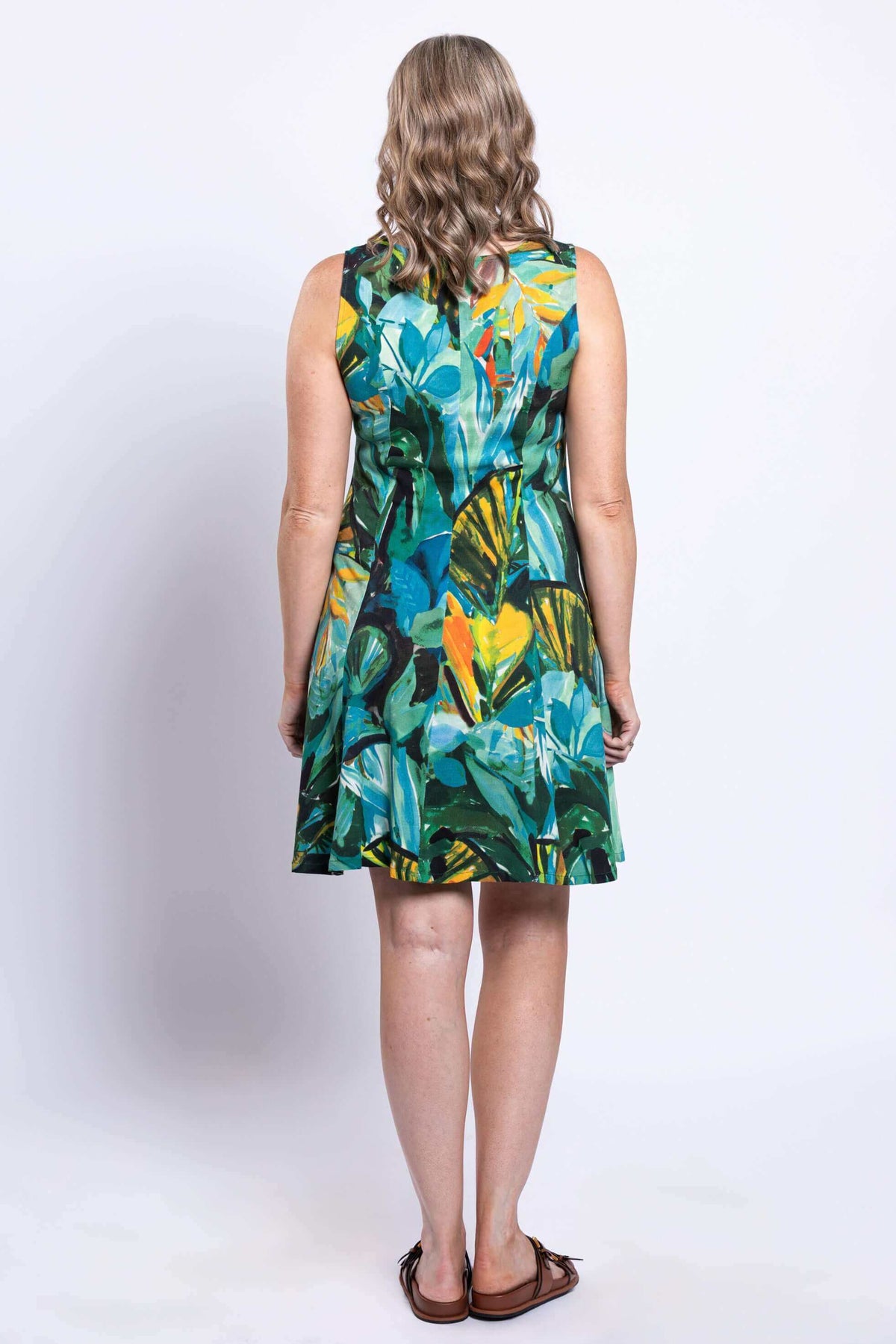 Back view of woman wearing the knee-length rainforest bamboo linen dress, showing the full pattern