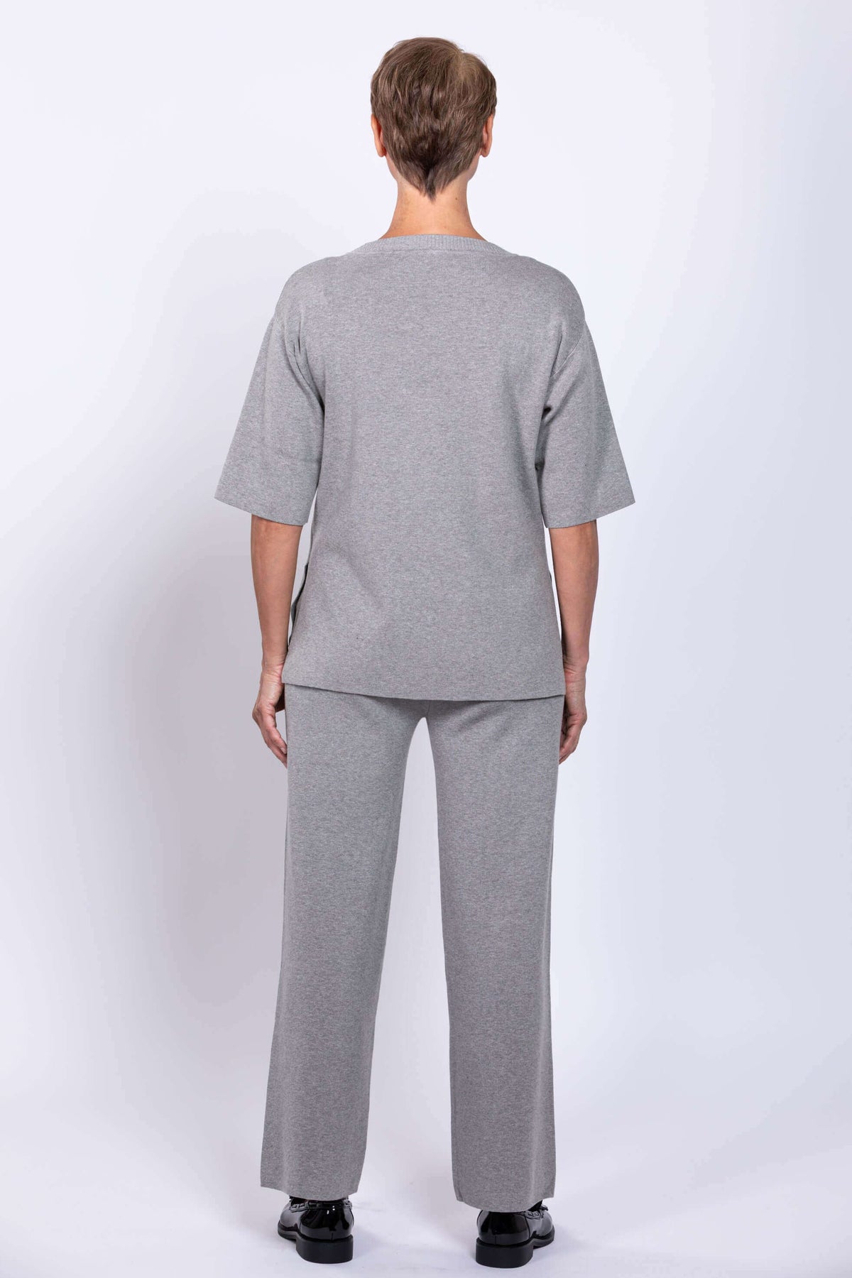 Back view of model in Bailey grey track pants and matching top