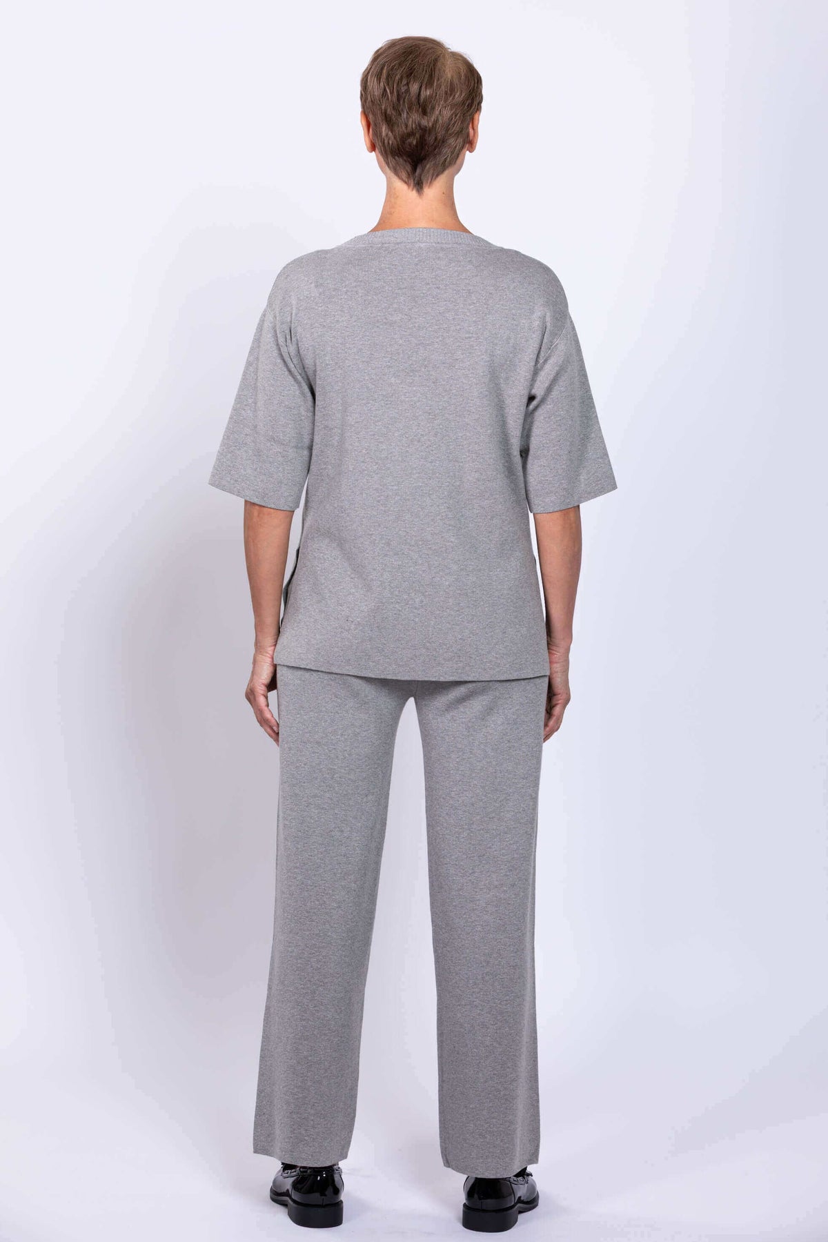 Back view of woman in grey Bailey track pant and top